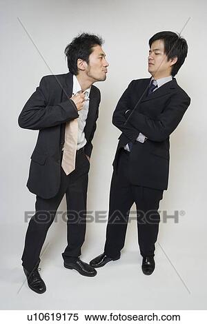 Stock Photography - Two businessmen glaring each other. Fotosearch