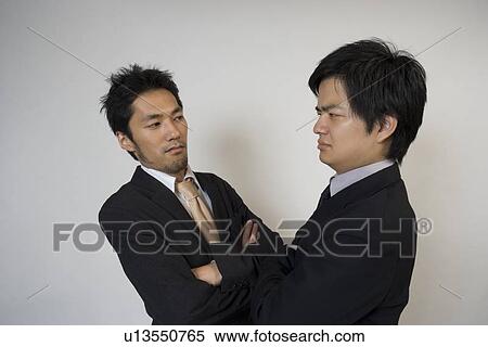Two businessmen glaring each other View Large Photo Image Stock Photography - Two businessmen glaring each other. Fotosearch
