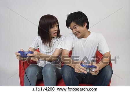 Two people playing video game View Large Photo Image Stock Image - Two people playing video game. Fotosearch