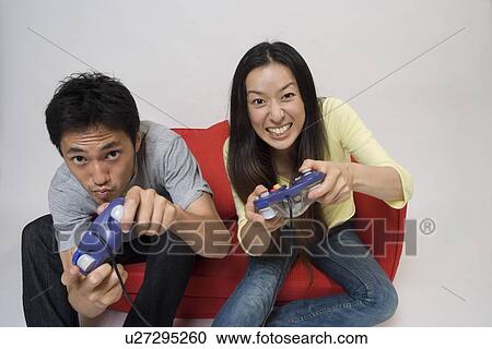 Two people playing video game View Large Photo Image Stock Image - Two people playing video game. Fotosearch