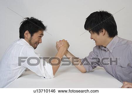 Two young men arm wrestling View Large Photo Image Stock Photograph - Two young men arm wrestling. Fotosearch