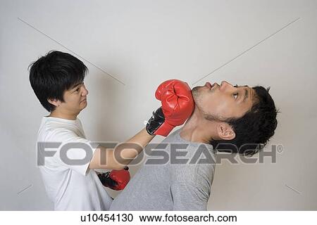 Stock Image - Two young men fighting. Fotosearch