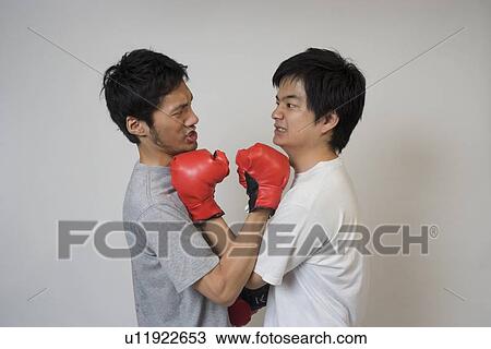 Two young men fighting View Large Photo Image Stock Image - Two young men fighting. Fotosearch