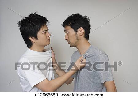 Two young men fighting View Large Photo Image Stock Image - Two young men fighting. Fotosearch