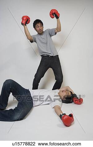 Stock Image - Two young men fighting. Fotosearch