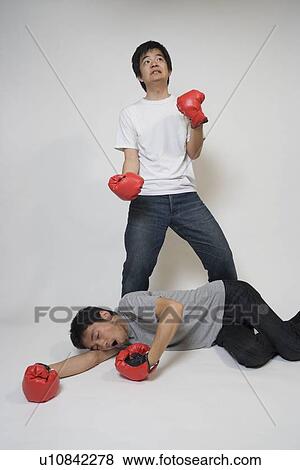 Stock Photo - Two young men fighting. Fotosearch