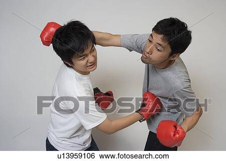 Two young men fighting View Large Photo Image Stock Photograph - Two young men fighting. Fotosearch