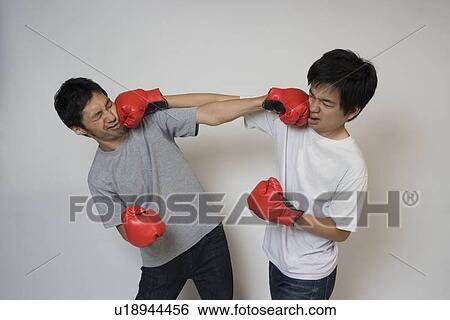 Stock Photograph - Two young men fighting. Fotosearch