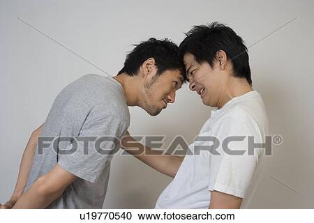 Two young men glaring View Large Photo Image Stock Image - Two young men glaring. Fotosearch