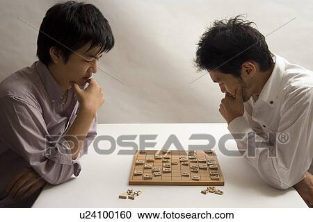 Two young men playing Japanese chess View Large Photo Image Stock Image - Two young men playing Japanese chess. Fotosearch