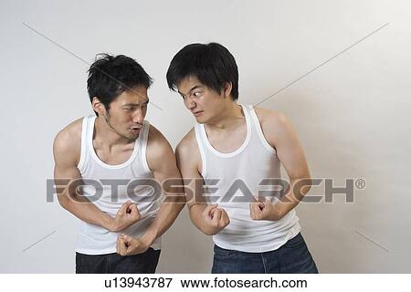 Two young men showing muscle each other View Large Photo Image Stock Photo - Two young men showing muscle each other. Fotosearch
