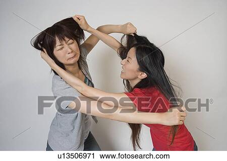 Two young women fighting View Large Photo Image Stock Image - Two young women fighting. Fotosearch