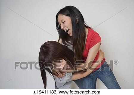 Stock Image - Two young women fighting. Fotosearch