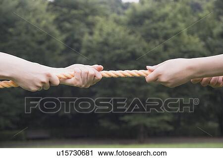 Two young women pulling rope View Large Photo Image Stock Image - Two young women pulling rope. Fotosearch