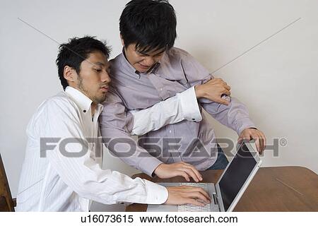 Young man trying to occupy computer View Large Photo Image Stock Photography - Young man trying to occupy computer. Fotosearch