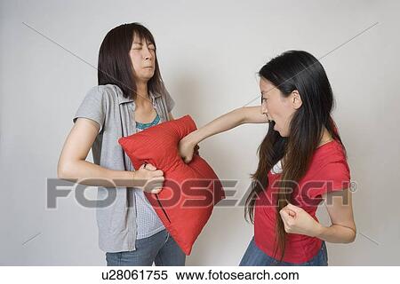 Stock Photography - Young woman bullying another woman. Fotosearch