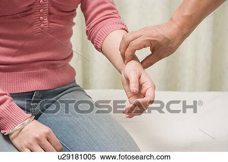 Doctor diagnosing pulse of patient View Large Photo Image Stock Photography - Doctor diagnosing pulse of patient. Fotosearch