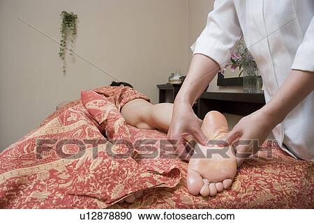 Therapist massaging patient's foot View Large Photo Image Stock Image - Therapist massaging patient's foot. Fotosearch