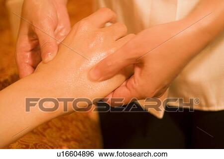 Stock Photograph - Therapist massaging patient's hand. Fotosearch