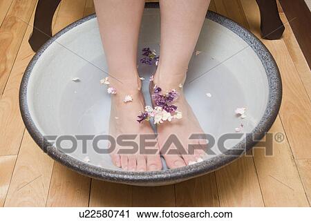 Young woman putting her legs in footbath View Large Photo Image Stock Image - Young woman putting her legs in footbath. Fotosearch