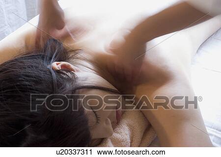 Stock Image - Young woman receiving massage, blurred motion. Fotosearch