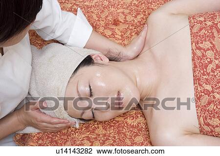 Young woman receiving massage View Large Photo Image Stock Image - Young woman receiving massage. Fotosearch