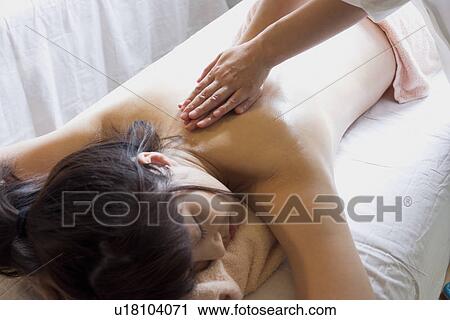 Young woman receiving massage View Large Photo Image Stock Image - Young woman receiving massage. Fotosearch