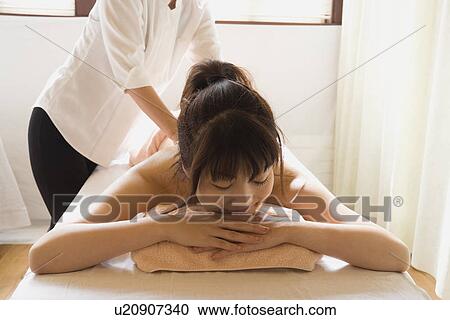 Young woman receiving massage View Large Photo Image Stock Image - Young woman receiving massage. Fotosearch