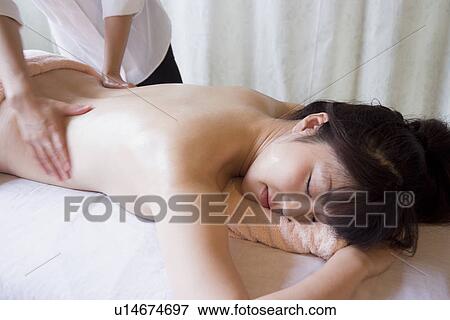 Young woman receiving massage View Large Photo Image Stock Photo - Young woman receiving massage. Fotosearch