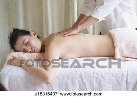 Stock Photo - Young woman receiving massage. Fotosearch