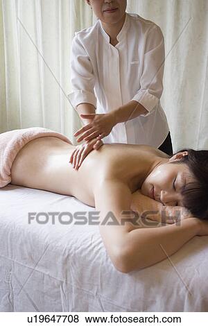 Stock Photo - Young woman receiving massage. Fotosearch