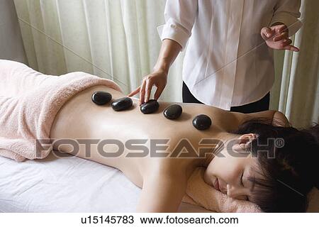 Young woman receiving stone massage View Large Photo Image Stock Image - Young woman receiving stone massage. Fotosearch