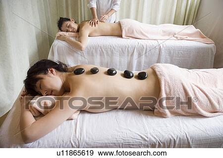 Young woman receiving stone massage View Large Photo Image Stock Photo - Young woman receiving stone massage. Fotosearch