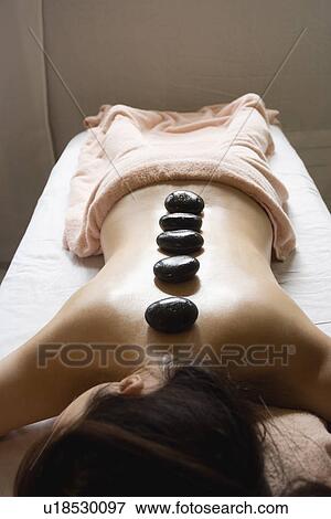 Young woman receiving stone massage View Large Photo Image Stock Photo - Young woman receiving stone massage. Fotosearch