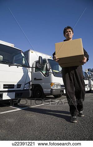 Driver carrying a box View Large Photo Image Stock Image - Driver carrying a box. Fotosearch