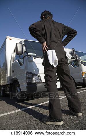 Driver standing in parking View Large Photo Image Stock Photograph - Driver standing in parking. Fotosearch