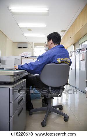 Stock Photo - Mature man sitting in office. Fotosearch