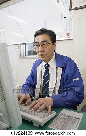 Stock Photo - Mature man using computer. Fotosearch