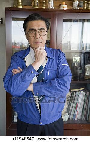 Stock Photo - Mature man with his hand on chin. Fotosearch