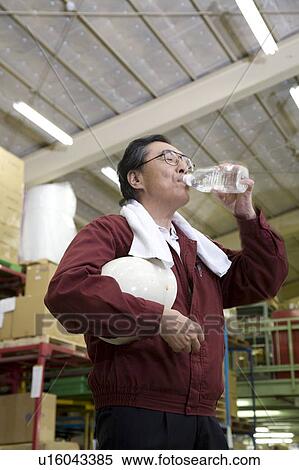 Senior worker drinking water View Large Photo Image Stock Photography - Senior worker drinking water. Fotosearch