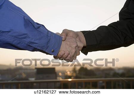 Stock Photo - Two men shaking hands. Fotosearch