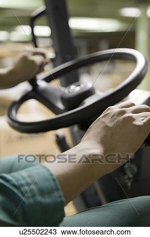 Young man using forklift View Large Photo Image Stock Image - Young man using forklift. Fotosearch