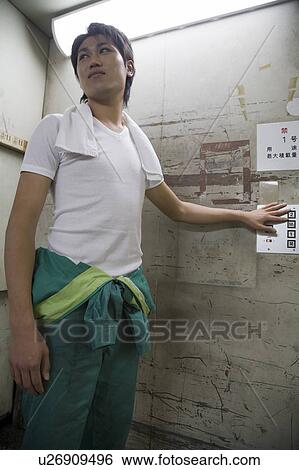 Young man using warehouse elevator View Large Photo Image Stock Photograph - Young man using warehouse elevator. Fotosearch