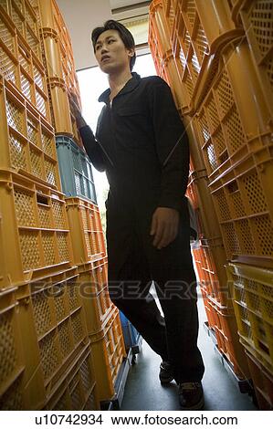 Young warehouse worker walking View Large Photo Image Picture - Young warehouse worker walking. Fotosearch