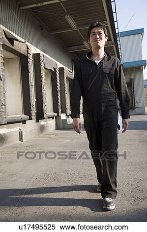 Young warehouse worker walking View Large Photo Image Stock Photography - Young warehouse worker walking. Fotosearch