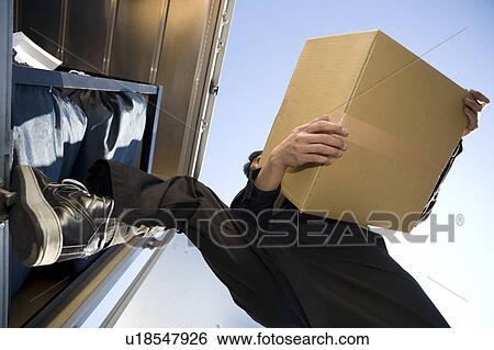 Young worker carrying box View Large Photo Image Stock Photograph - Young worker carrying box. Fotosearch