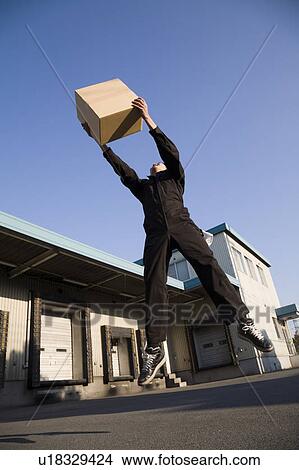 Picture - Young worker jumping. Fotosearch