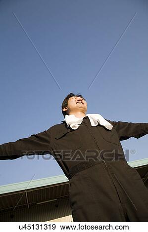 Stock Photo - Young worker stretching. Fotosearch