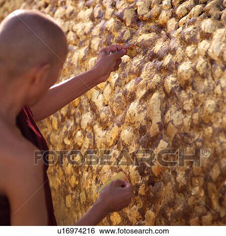 Monk putting gold leaf gilding on Golden Rock Shrine View Large Photo Image Stock Photograph - Monk putting gold leaf gilding on Golden Rock Shrine. Fotosearch