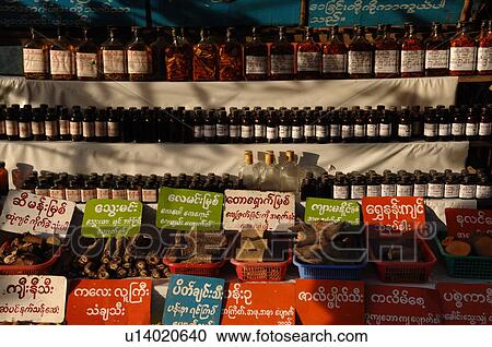 Stock Image - Row of bottles on a shelf. Fotosearch